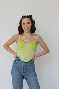 girl wearing lime green corset top