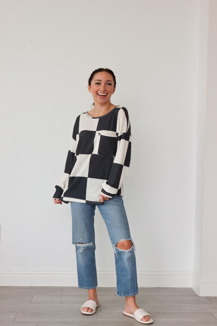 girl wearing black and white checkered longsleeved top