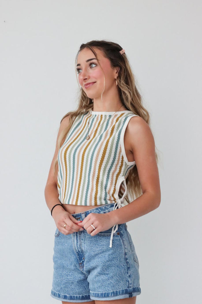 girl wearing multicolored striped tank top with ruched side detailing