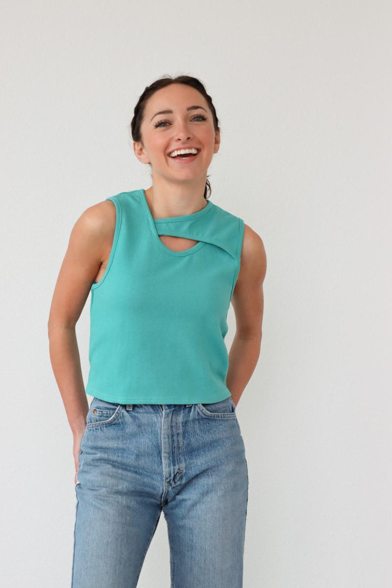 girl wearing teal tank top with asymmetrical cutout 