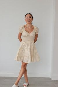 girl wearing cream dress with ruche detailing