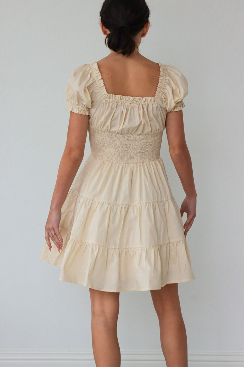 girl wearing cream dress with ruche detailing