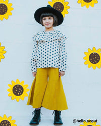 young girl posing with sunflower drawings around her