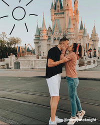 Couple kissing with disney castle in background and drawn sun doodle