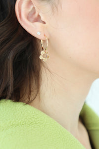 girl wearing flower hoop earrings