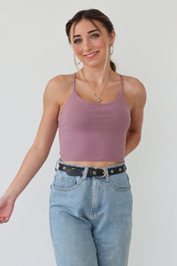 girl wearing purple athletic tank top with thin straps and built in padded bra