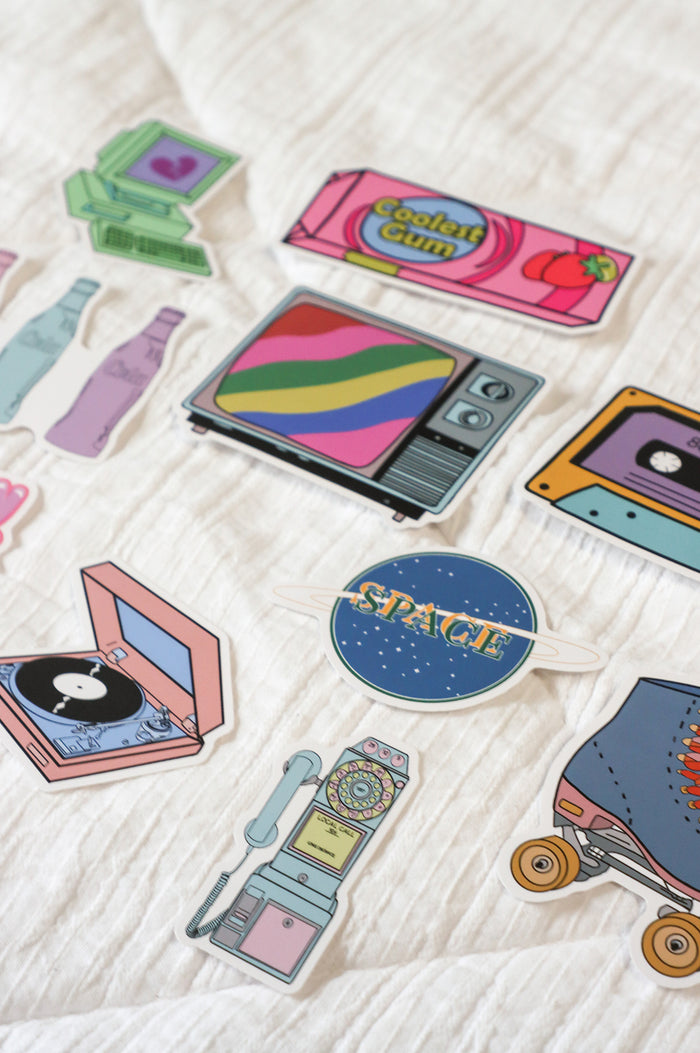 12 sticker set - green vintage computer, pink strawberry bubble gum, "have a blast," pink blue purple cola bottles, retro tv static, 80's caset tape, "space" with a saturn ring, roller skate, rubicks cube, "made in the 00's", record player, dial up vintage phone