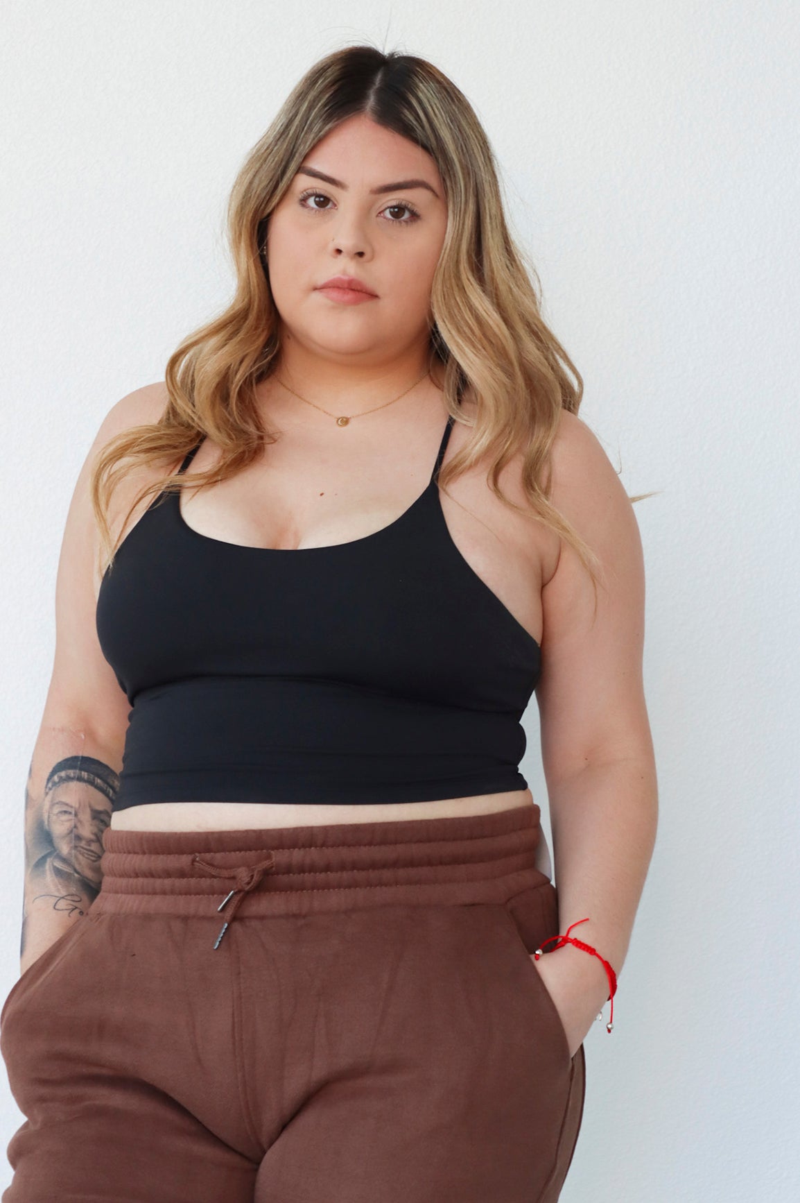 female model that is 5'1" wearing a size 2xl black athletic tank top with padding