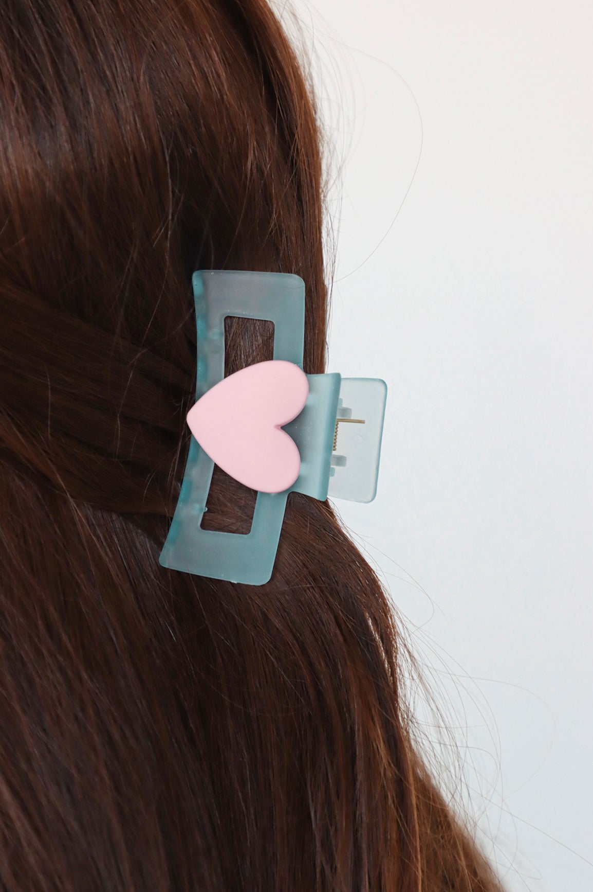 Blue heart shaped claw clip in hair