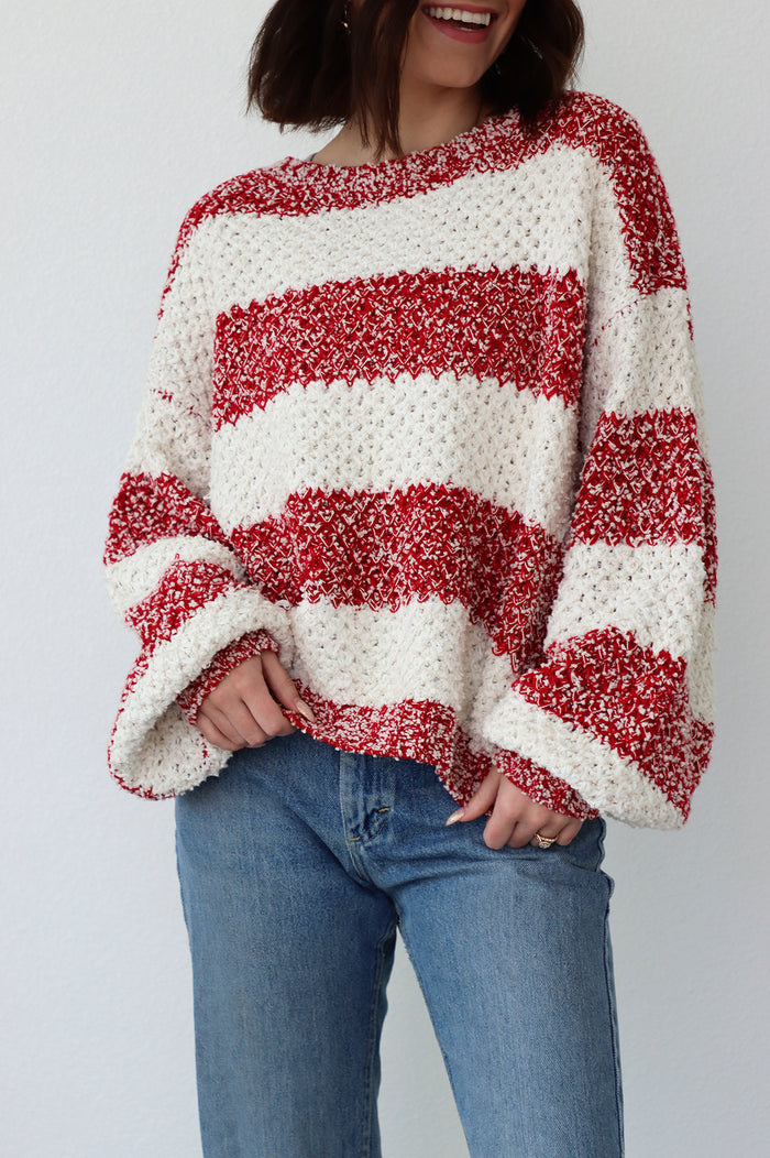 girl wearing red and white striped oversized sweater