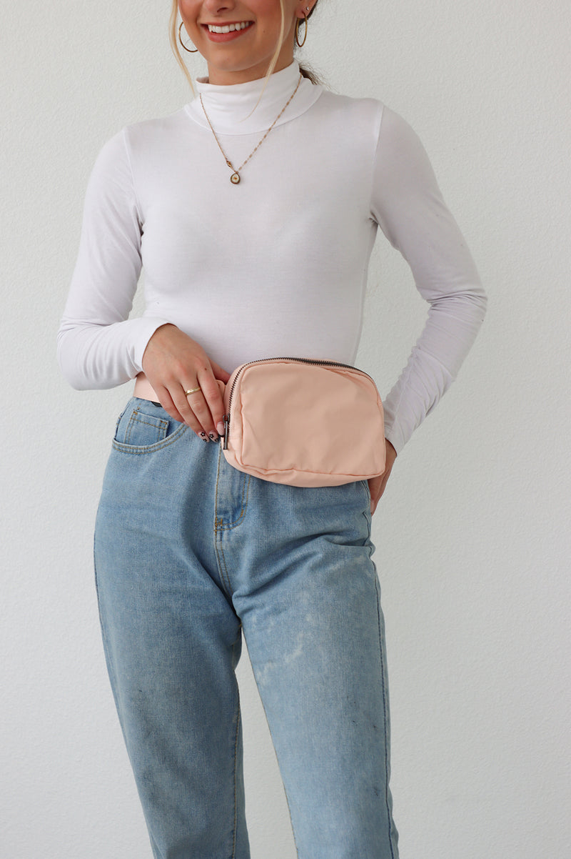 girl wearing pink belt bag around waist