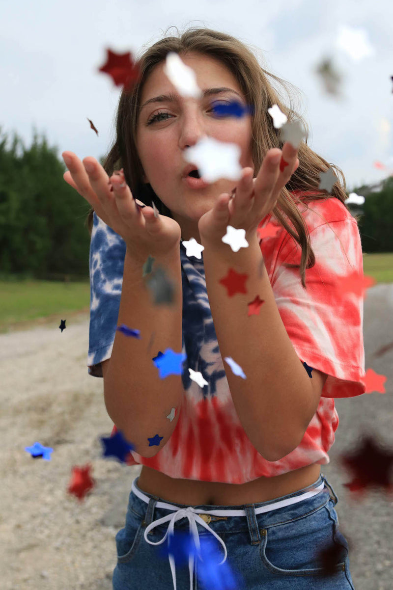 bloom preset before photo of a girl blowing confetti