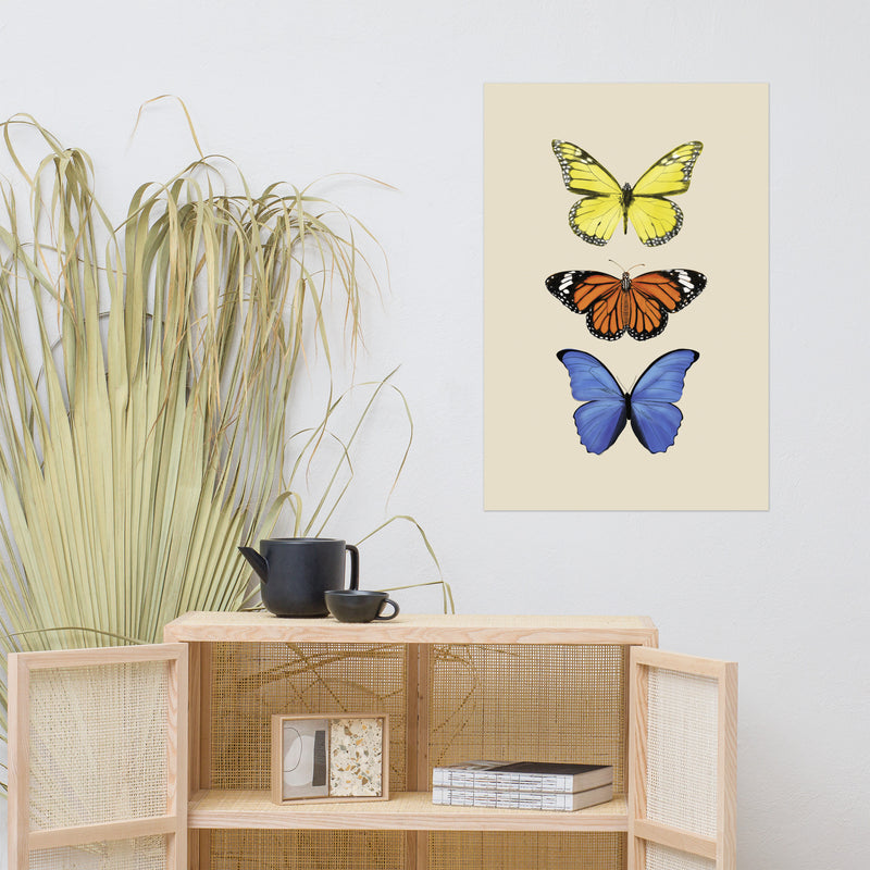 three butterflies with yellow, orange, and then blue in a vertical line