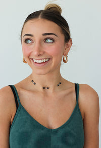 girl wearing black beaded choker necklace