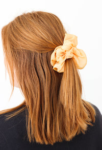 girl wearing yellow scrunchie in her hair