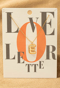 E letter gold necklace
