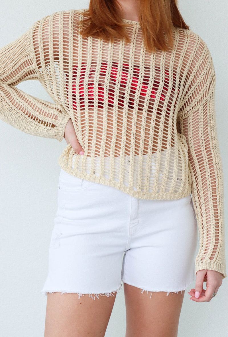 girl wearing tan crochet long-sleeve top
