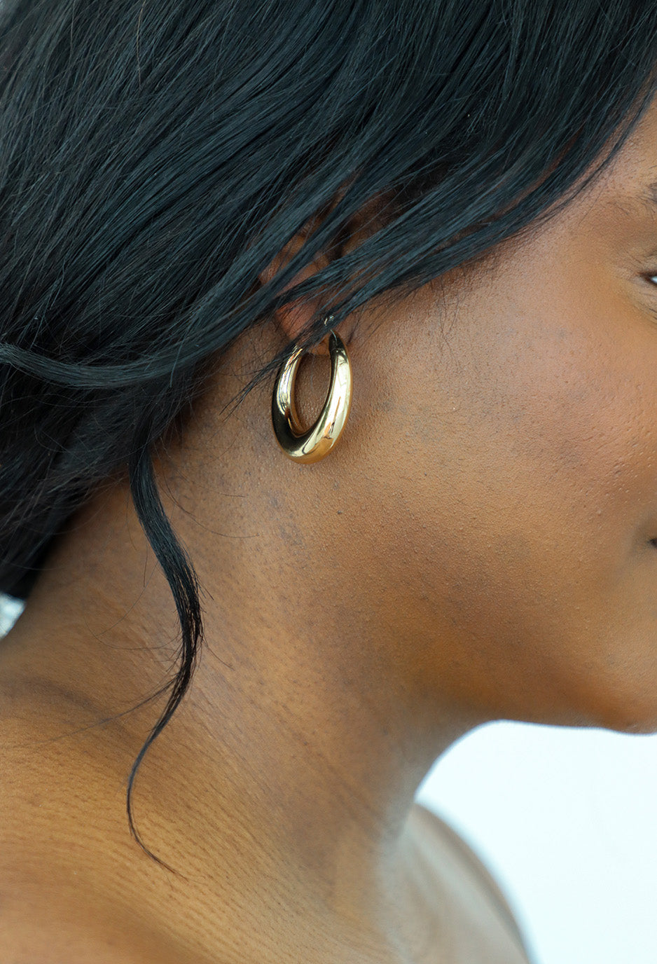 girl wearing gold earrings